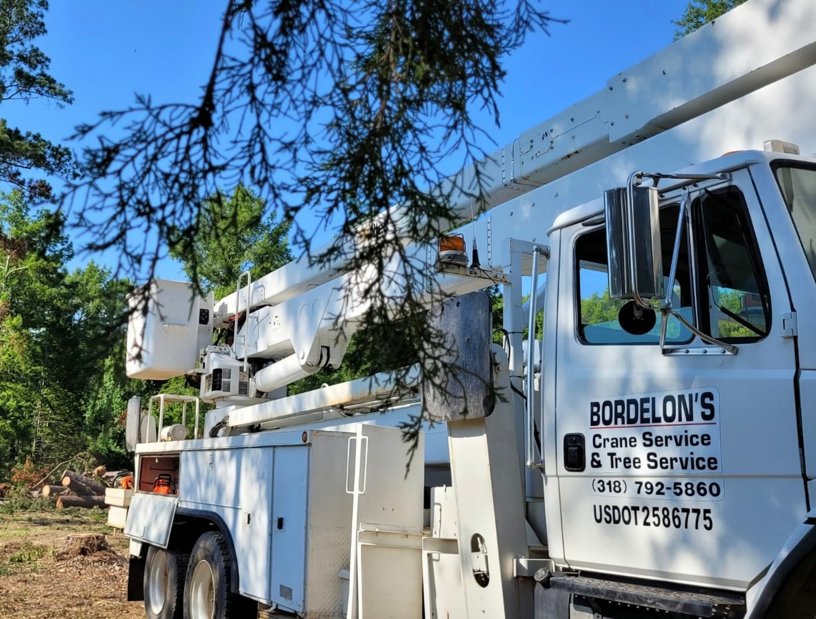 Bordelon's bucket truck parked at a cleared jobsite